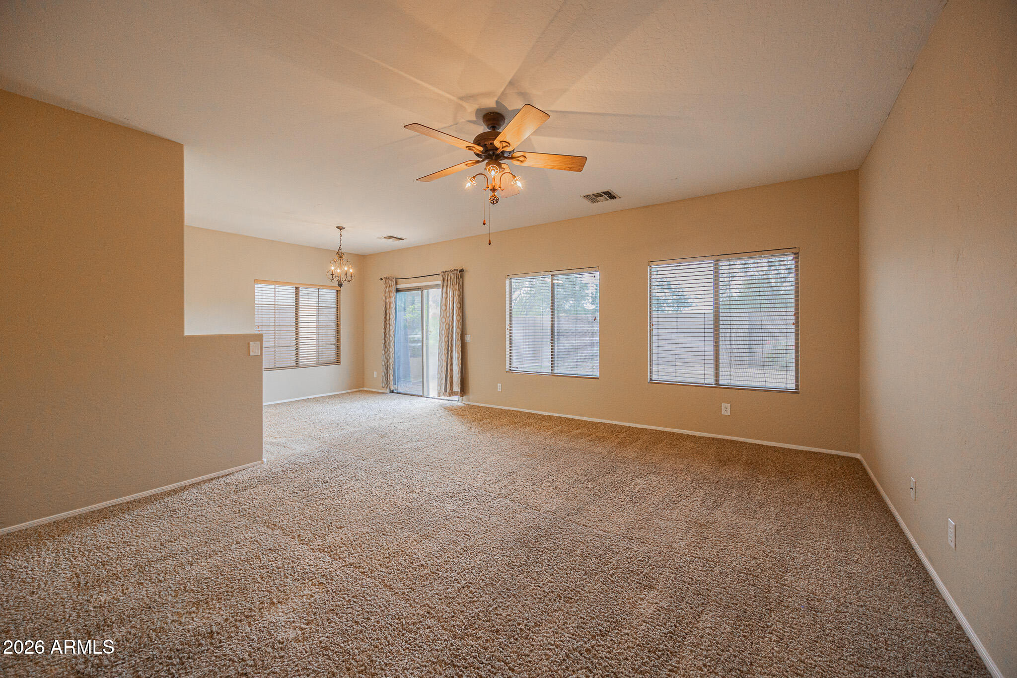 6426 South Nash Way Chandler, AZ 85249 - Photo 4 of 23 a view of a livingroom with a ceiling fan and window