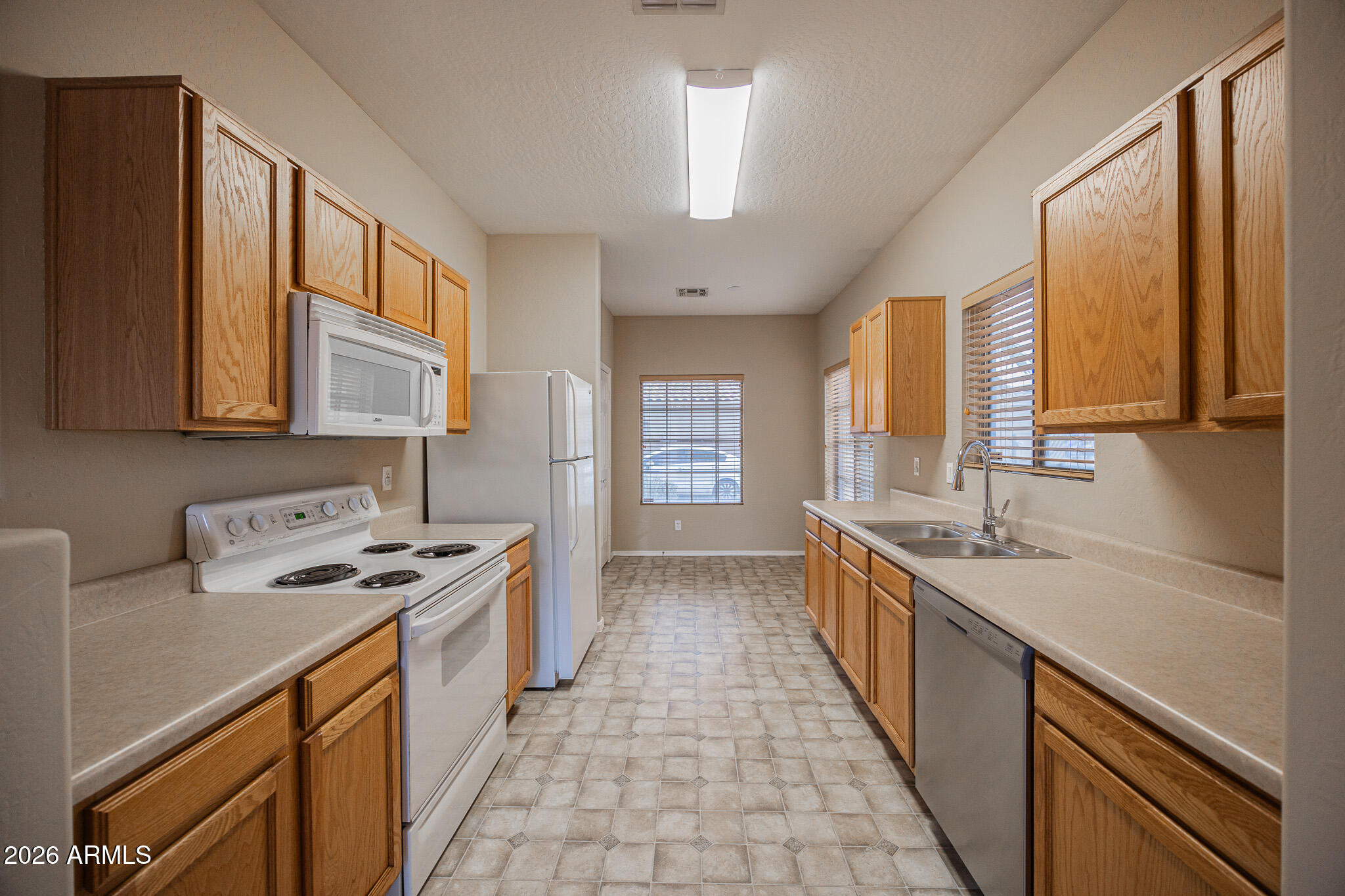 6426 South Nash Way Chandler, AZ 85249 - Photo 8 of 23 a kitchen with stainless steel appliances a sink stove and cabinets