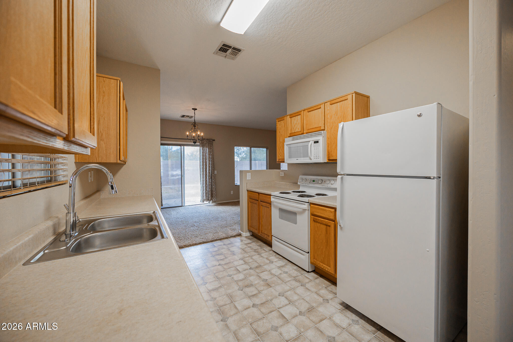6426 South Nash Way Chandler, AZ 85249 - Photo 10 of 23 a kitchen with stainless steel appliances granite countertop a refrigerator a sink and a stove