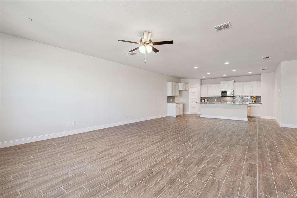 6028 Bursey Road Watauga, TX 76148 - Photo 8 of 27 a view of kitchen with wooden floor and a kitchen island