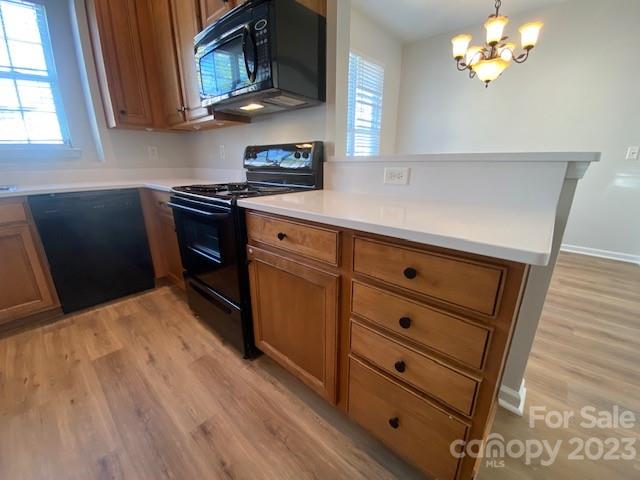 948 Copperstone Lane Fort Mill, SC 29708 - Photo 6 of 34 a kitchen with stainless steel appliances a stove a microwave and white cabinets