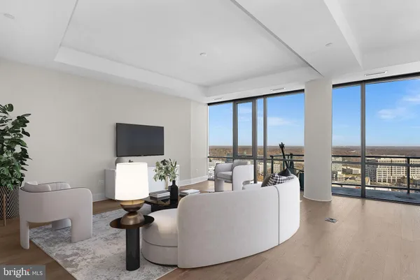 a large kitchen with stainless steel appliances a large counter top a stove and a refrigerator