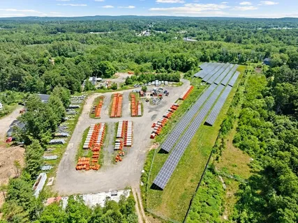an aerial view of a house with a yard and balcony