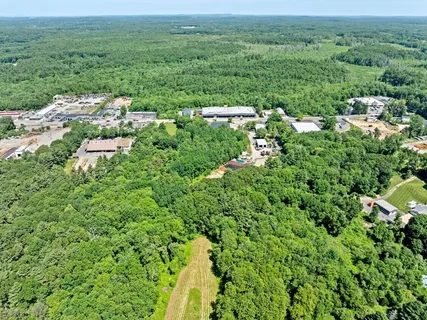 an aerial view of residential houses with outdoor and green space