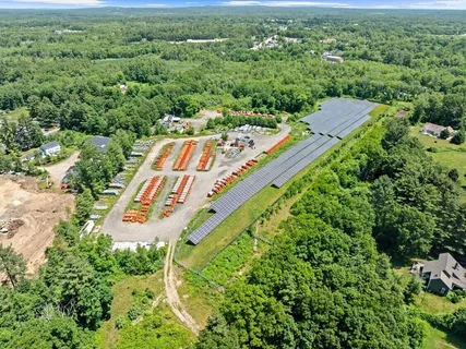 an aerial view of a house with a yard and lake view