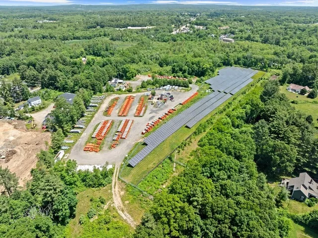 an aerial view of a house with a yard and lake view
