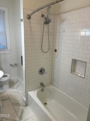 a bathroom with a shower and a toilet