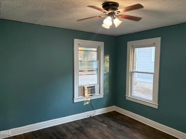 a bedroom with a window and ceiling fan