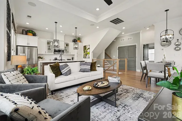 a living room with furniture and kitchen view