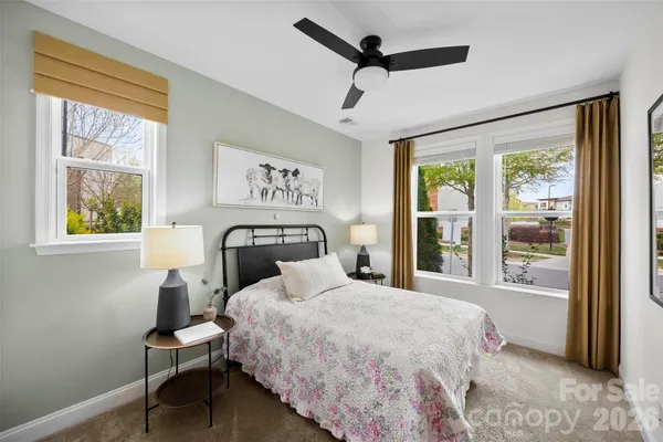 a living room with furniture a window and a chandelier