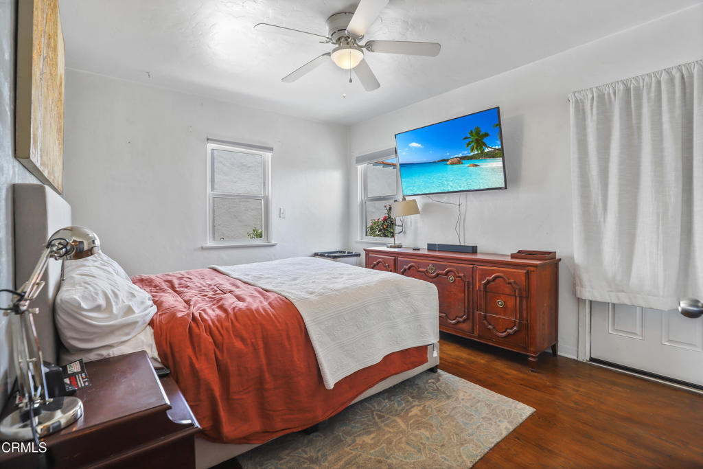 300 C Street Fillmore, CA 93015 - Photo 15 of 41 a bedroom with a bed and a chandelier