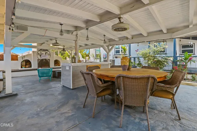 a living room with patio furniture and a garage