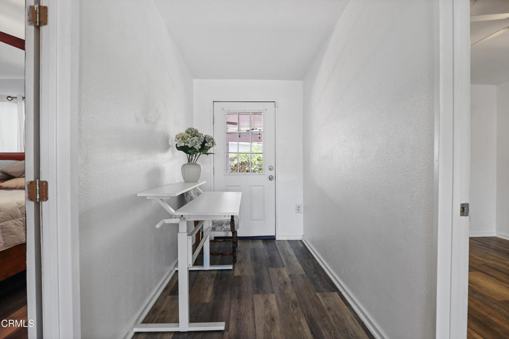 300 C Street Fillmore, CA 93015 - Photo 33 of 41 a view of a hallway with wooden floor and a dining room