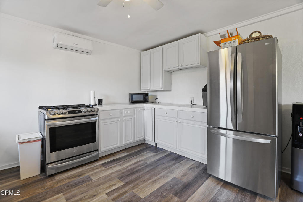 300 C Street Fillmore, CA 93015 - Photo 40 of 41 a kitchen with white cabinets and stainless steel appliances