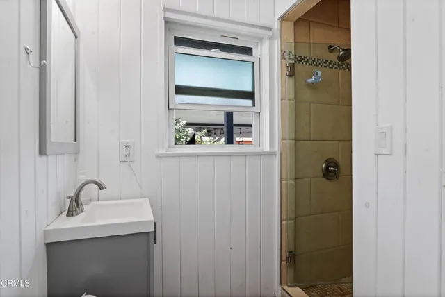 a bathroom with a sink and mirror