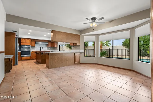 a stove top oven sitting inside of a kitchen