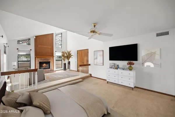 a view of a livingroom with furniture and chandelier fan