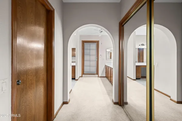 an empty room with chandelier fan