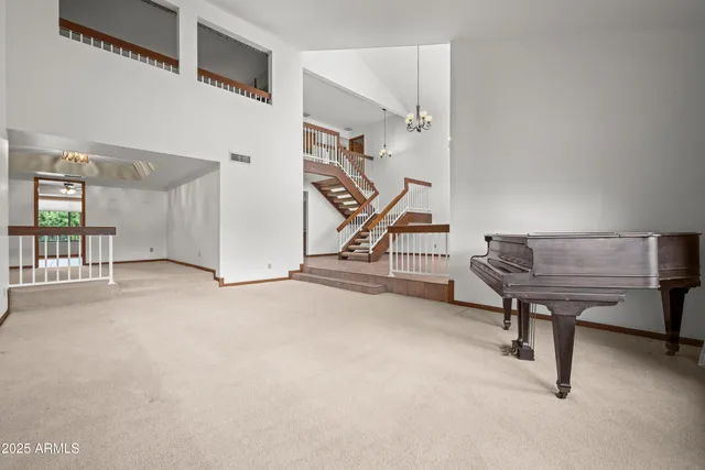 a view of an empty room with window and fireplace