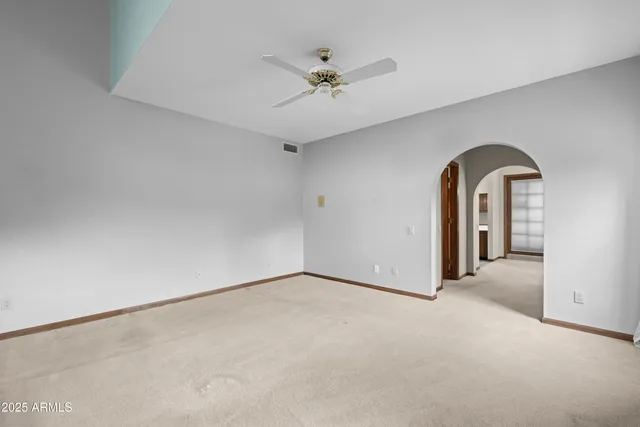 a view of a hallway with a sink and chandelier