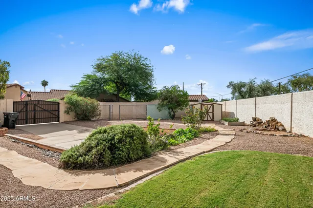 a view of a house with swimming pool and a yard