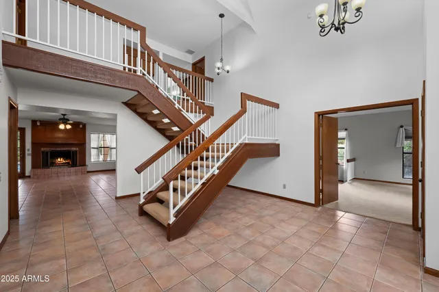 a view of an empty room with a fireplace and a window