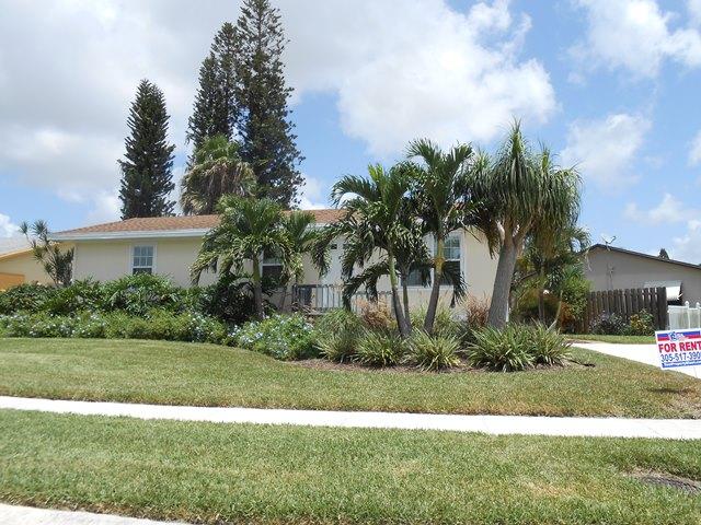 22829 Southwest 65th Way Boca Raton, FL 33428 - Photo 1 of 21 a front view of a house with garden