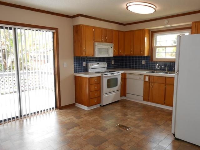 22829 Southwest 65th Way Boca Raton, FL 33428 - Photo 5 of 21 a kitchen with stainless steel appliances granite countertop a stove a sink and a microwave