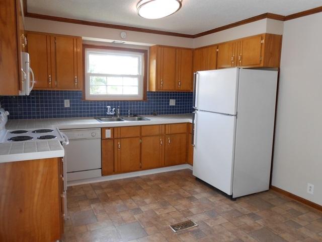 22829 Southwest 65th Way Boca Raton, FL 33428 - Photo 6 of 21 a kitchen with a refrigerator sink stove and cabinets