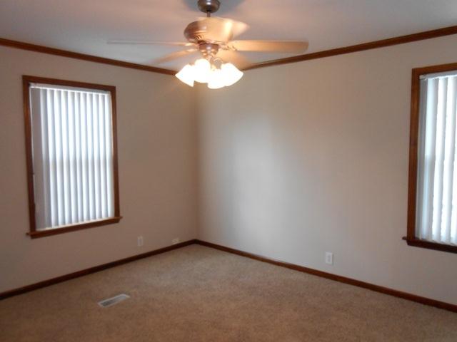 22829 Southwest 65th Way Boca Raton, FL 33428 - Photo 8 of 21 an empty room with windows and chandelier fan