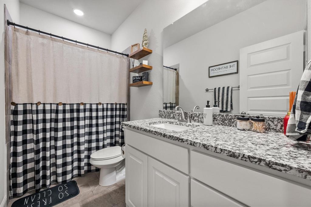 103 Randal Row Corsicana, TX 75110 - Photo 27 of 35 a bathroom with a granite countertop sink toilet and shower