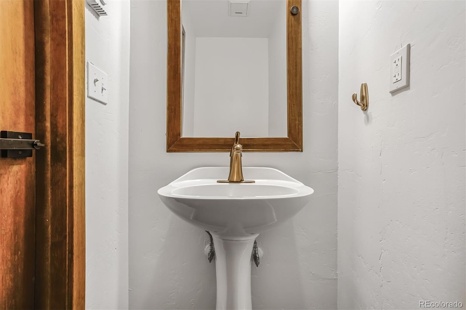 23646 Genesee Village Road Golden, CO 80401 - Photo 11 of 29 a bathroom with a sink and a mirror