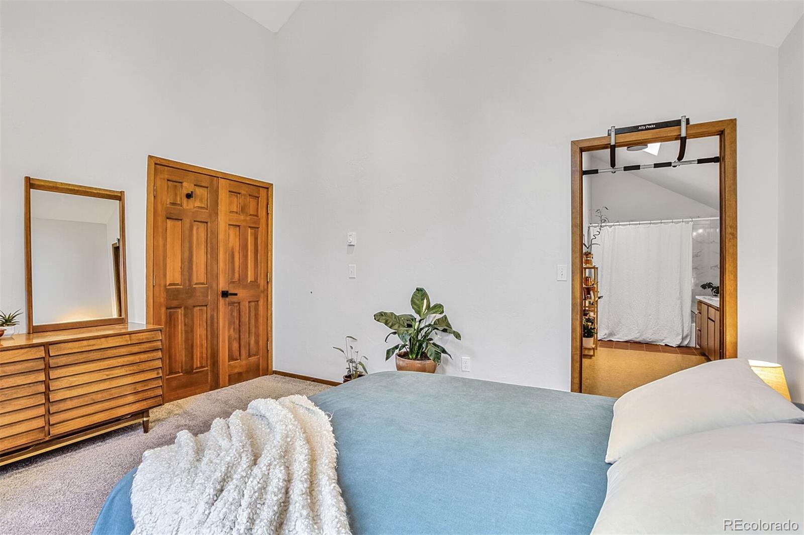 23646 Genesee Village Road Golden, CO 80401 - Photo 16 of 29 a bedroom with a bed and hallway