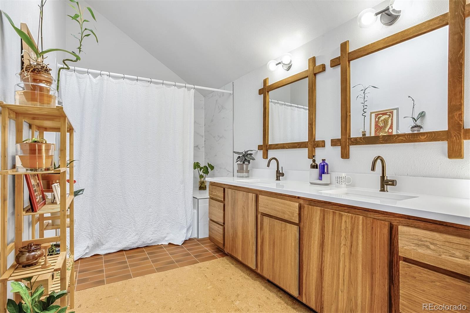 23646 Genesee Village Road Golden, CO 80401 - Photo 17 of 29 a bathroom with a double vanity sink and a mirror