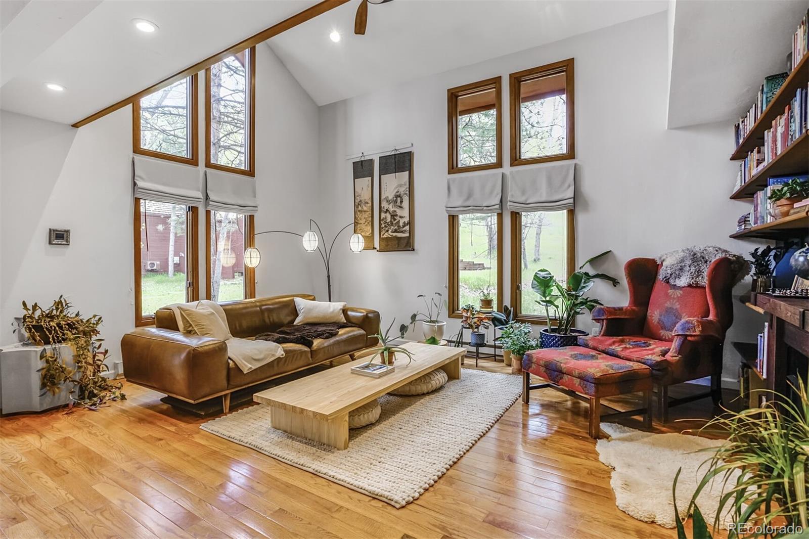 23646 Genesee Village Road Golden, CO 80401 - Photo 2 of 29 a living room with furniture fireplace and a large window