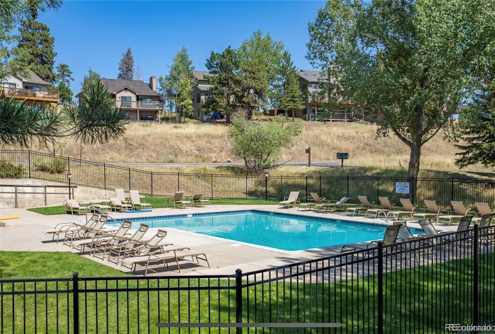 23646 Genesee Village Road Golden, CO 80401 - Photo 28 of 29 a view of a swimming pool and a terrace