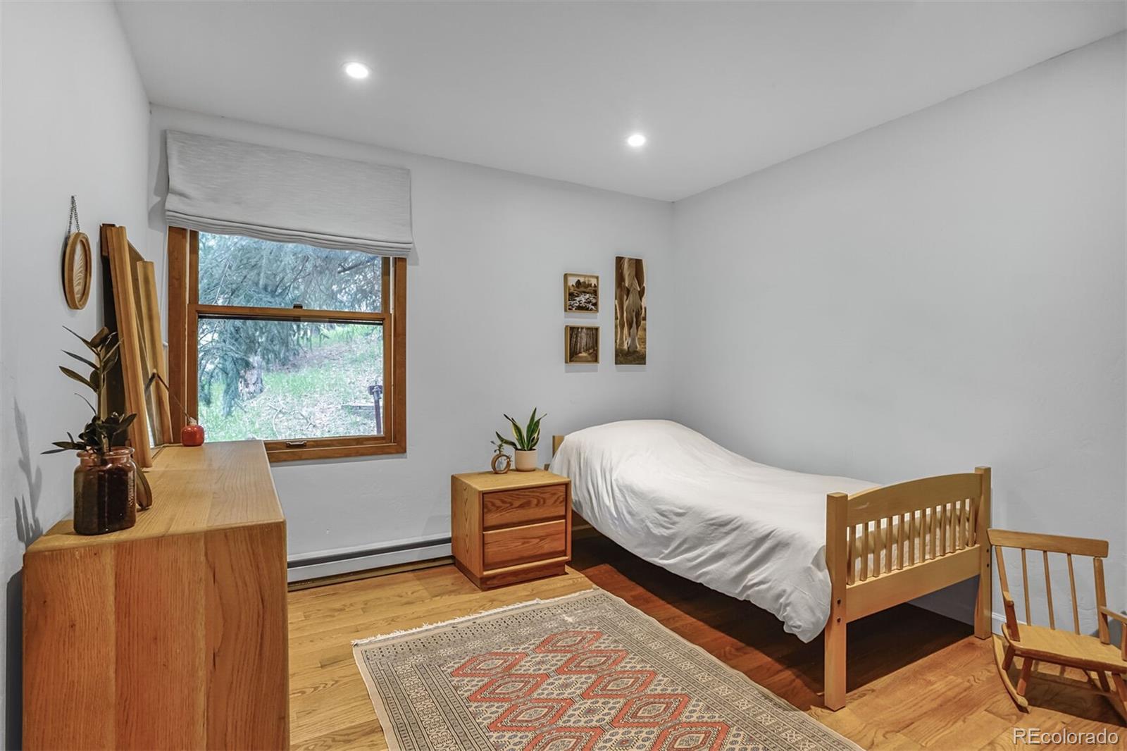 23646 Genesee Village Road Golden, CO 80401 - Photo 10 of 29 a bedroom with a bed and window
