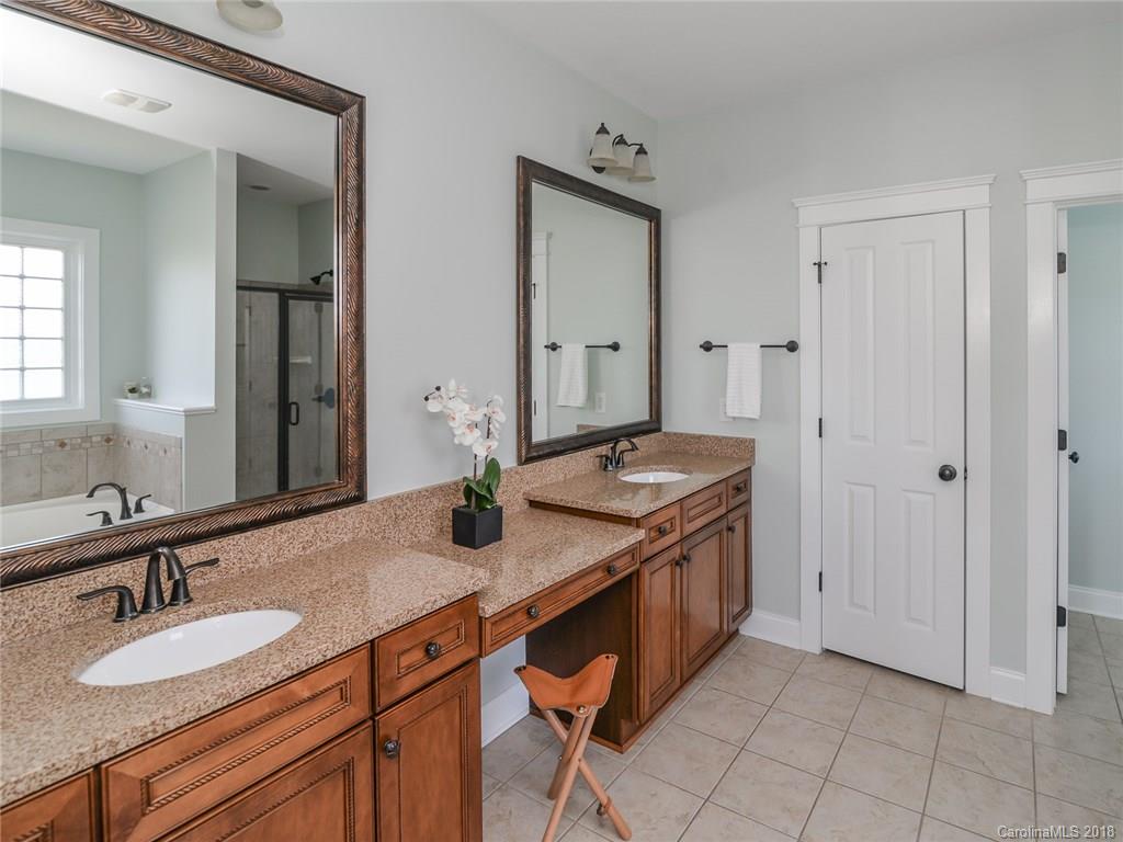 4317 Birkshire Heights Fort Mill, SC 29708 - Photo 15 of 23 a bathroom with a granite countertop sink and a mirror