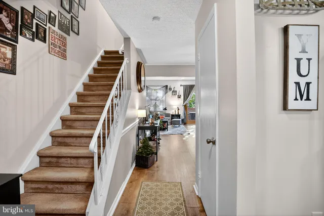 a view of entryway and hall with wooden floor