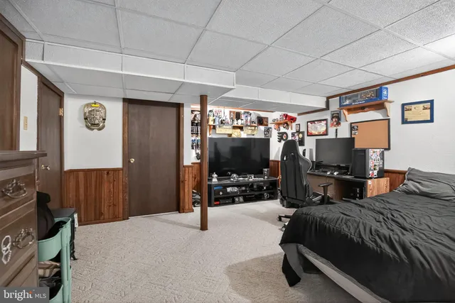 a bedroom with furniture and a flat screen tv
