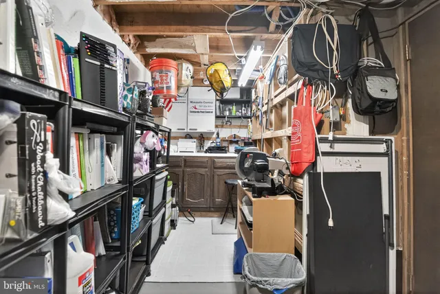 a view of a kitchen with stainless steel appliances kitchen island granite countertop a sink a stove and a refrigerator