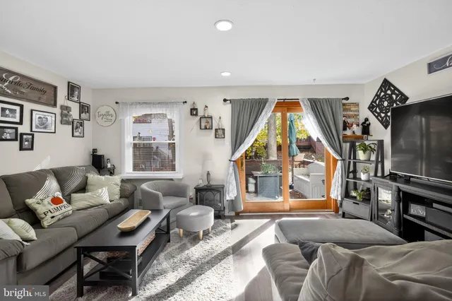 a bedroom with a bed couch and a window