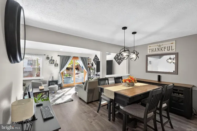 a living room with furniture a rug and a flat screen tv