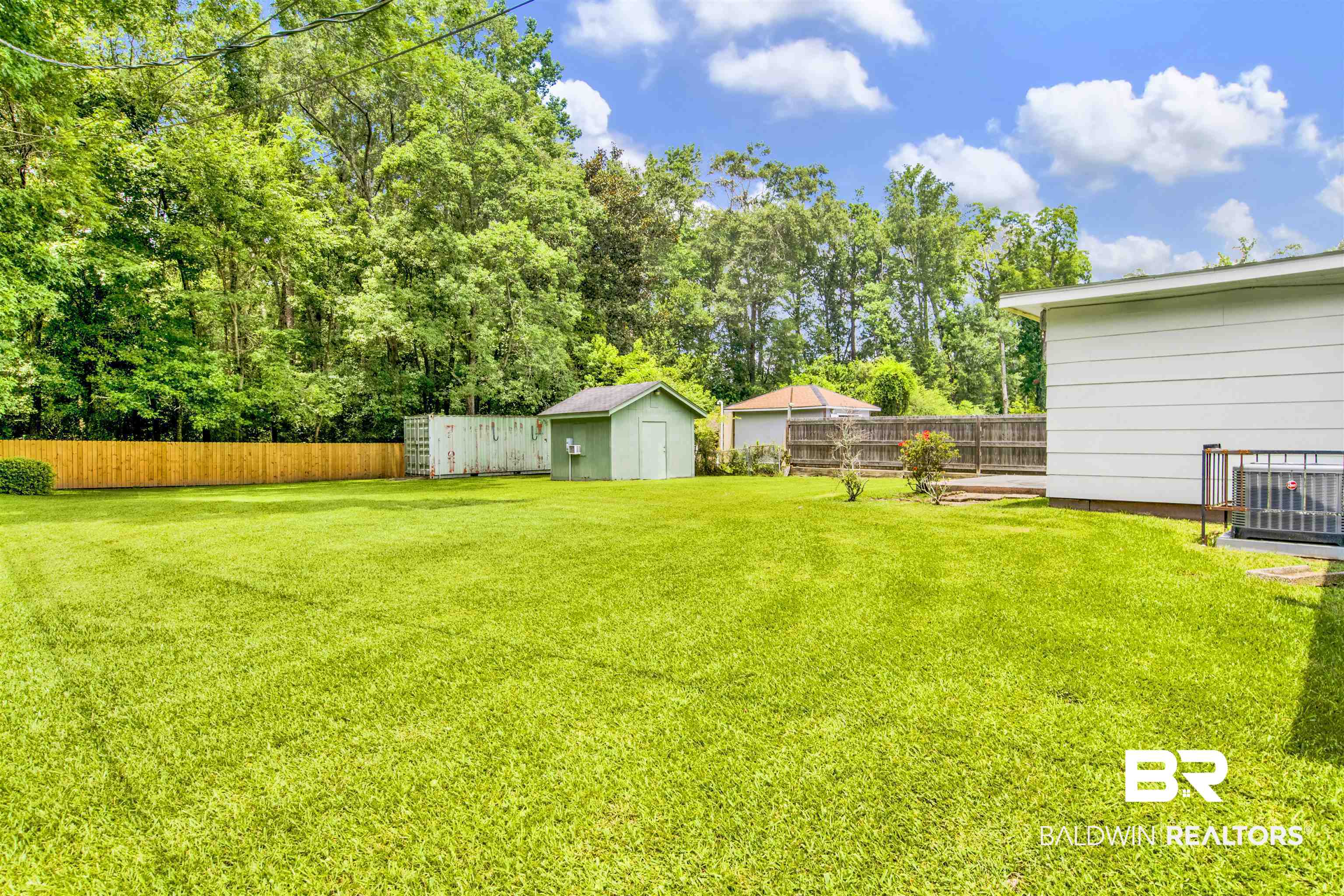 1476 Boudousquie Street Mobile, AL 36605 - Photo 26 of 34 Fenced backyard featuring a storage unit