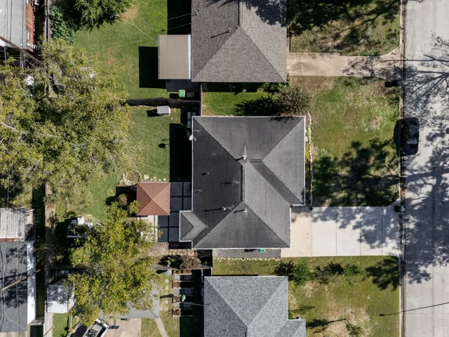 an aerial view of a house with a yard