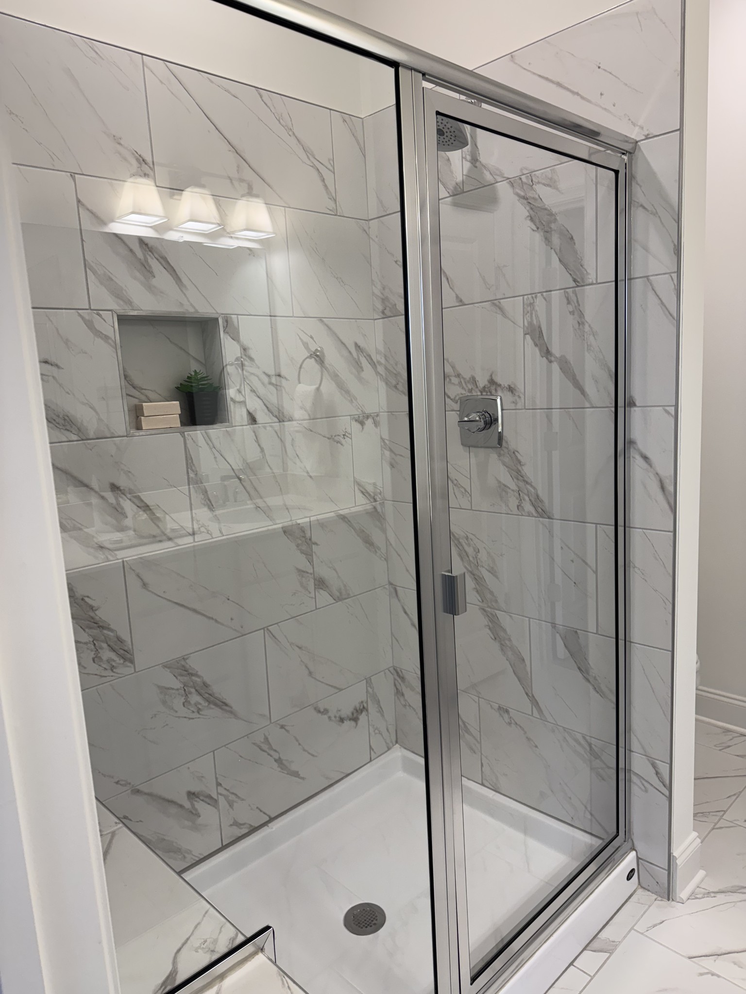 1166 June Wilde Ridge Spring Hill, TN 37174 - Photo 11 of 30 a bathroom with a glass shower door