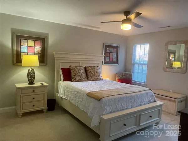 a bedroom with a bed dresser and a window