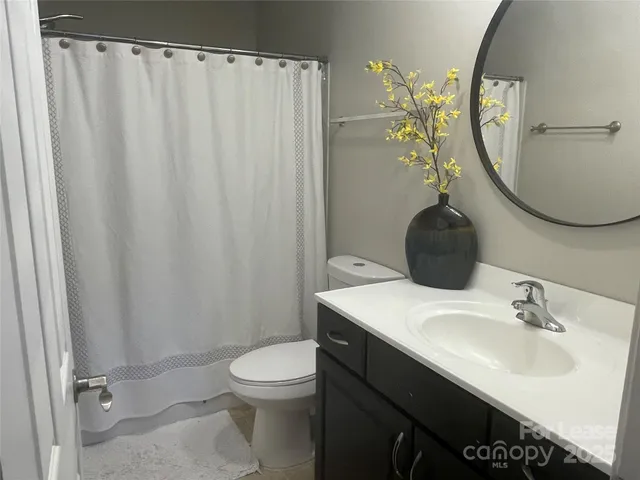 a bathroom with a sink toilet and mirror