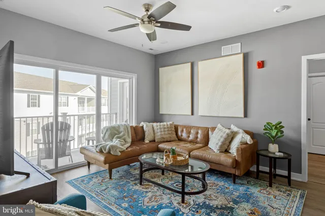 a living room with furniture kitchen and a table