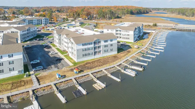 an aerial view of residential houses with outdoor space and river